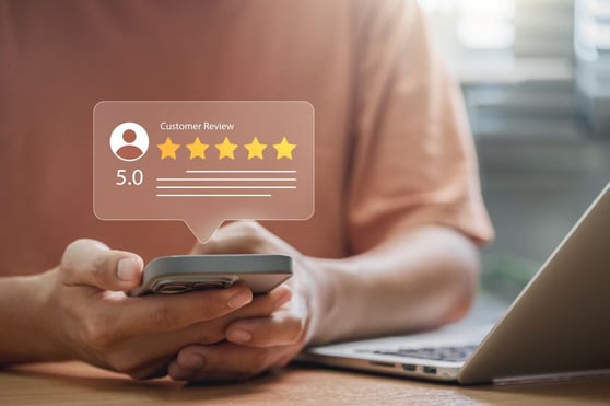 Customer checking 5-star feedback on mobile, showing how to manage reviews through real-time online reputation.