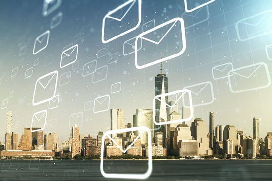 Email icons over a city skyline symbolizing the broad reach and impact of email marketing strategies.